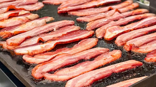 Image of Small Batch Bacon on a griddle.