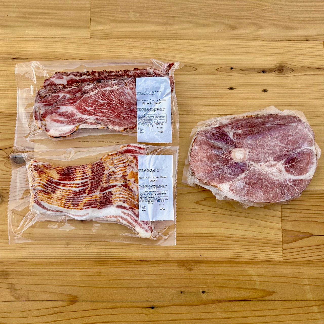 Contents of the Breakfast Lovers Box from Backstreet Market. Contains 1 pack bacon, 1 pack country bacon, and 1 ham steak.