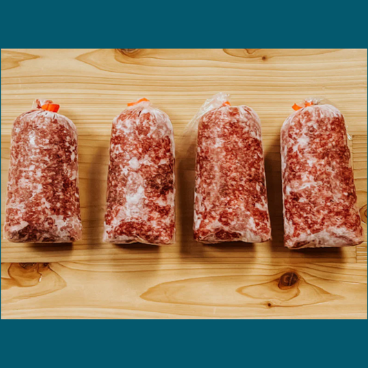 Four packages of ground wagyu cross beef from Remmele Custom Beef arranged on a cutting board.