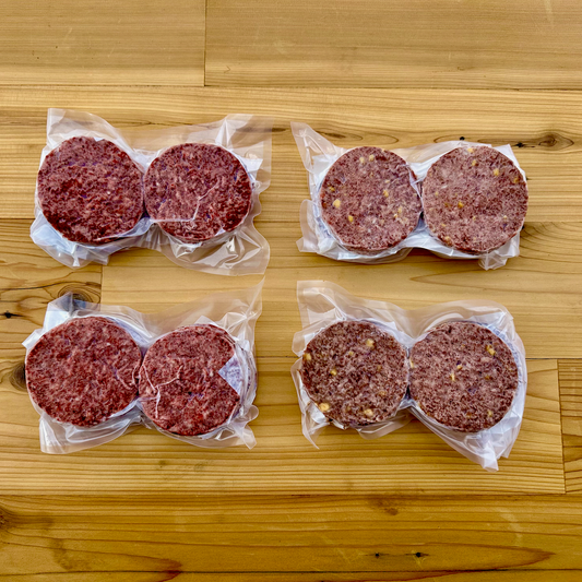 The contents of the American Wagyu Burger Patty Box from Verlinde Farms, consisting of 2 4-packs of one-third pound regular American Wagyu burger patties, and 2 4-packs of one-third pound cheddar bacon American Wagyu burger patties.