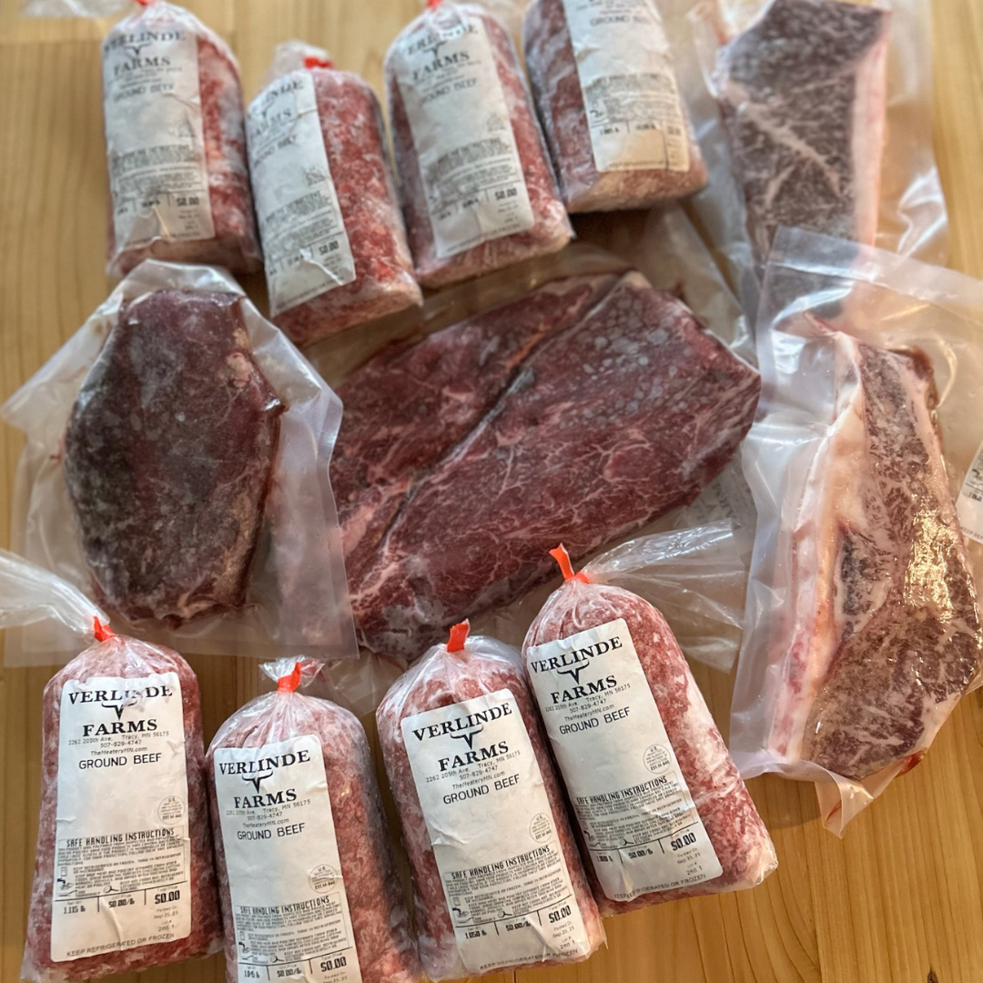 Contents of the American Wagyu Dream Box from Verlinde Farms, consisting of 8 packs of ground beef, boneless New York strip steaks, a flat iron steak, and a sirloin steak. 